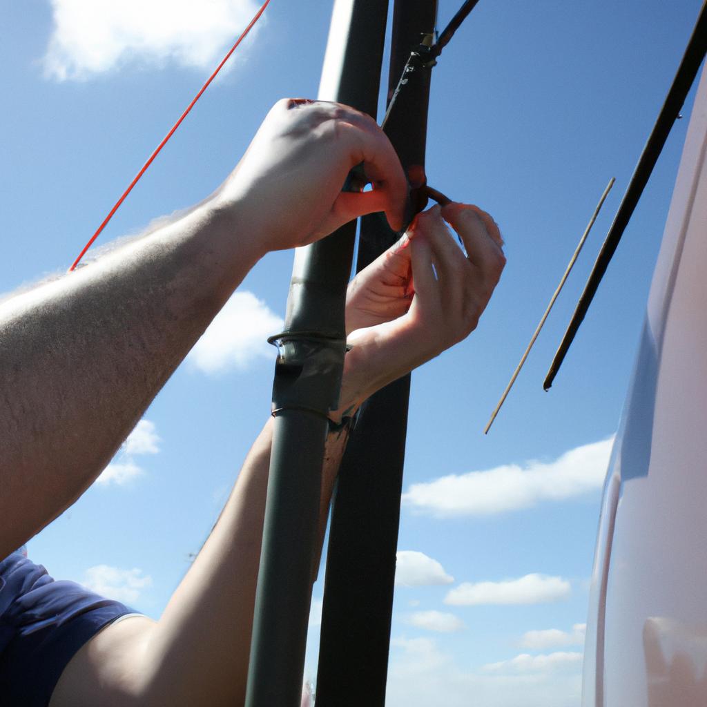 Person adjusting radio antenna equipment